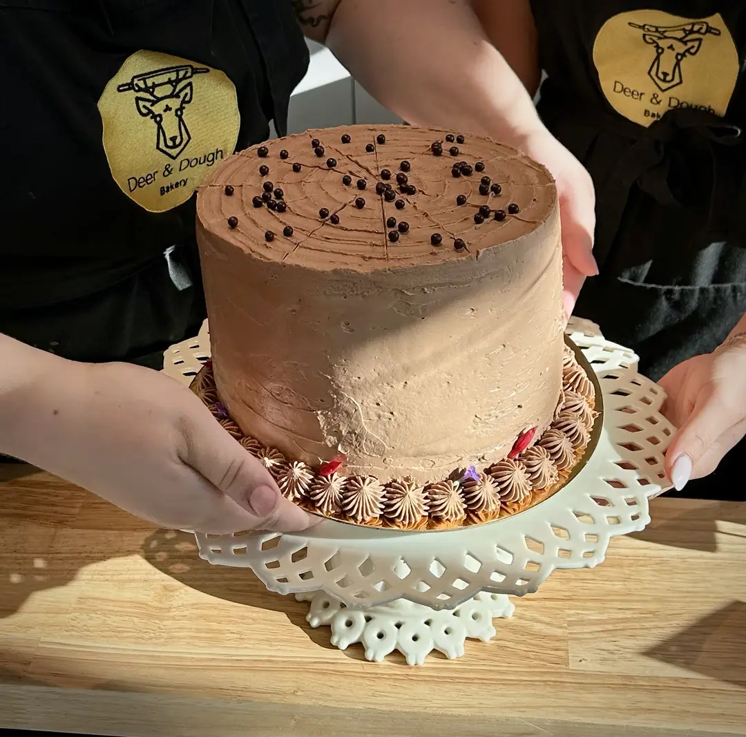 Chocolate cake on a lace stand.