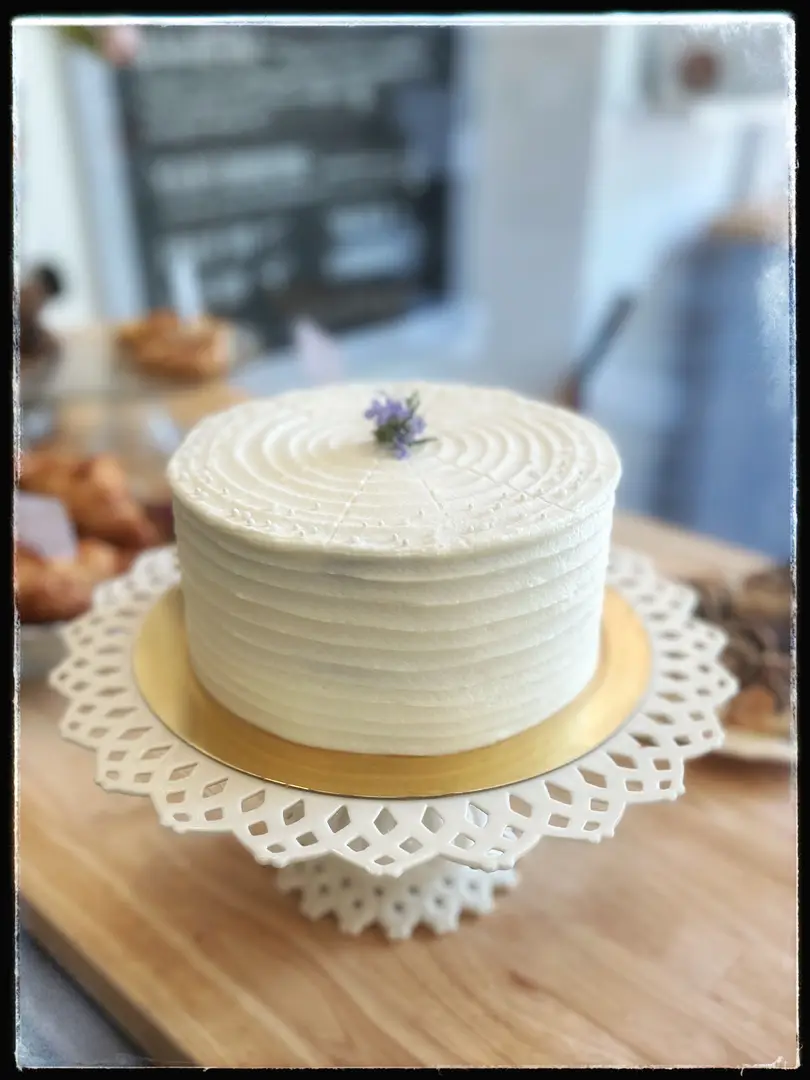 Elegant white cake on a stand.