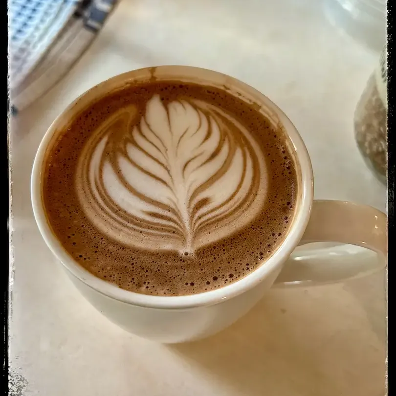 Latte art cappuccino in a ceramic cup.