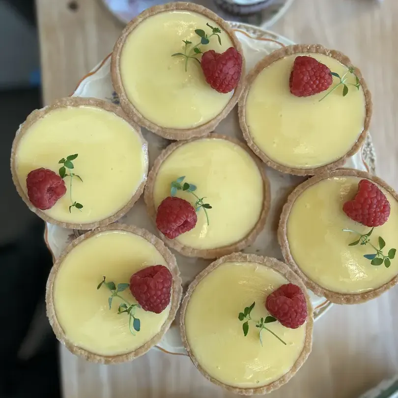 Lemon tarts with raspberries.