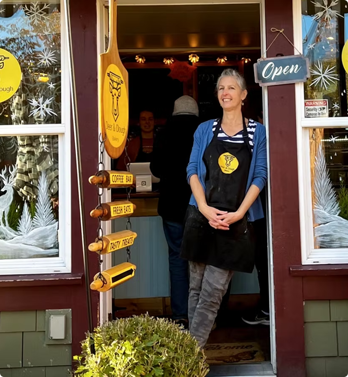 Owner standing in bakery doorway