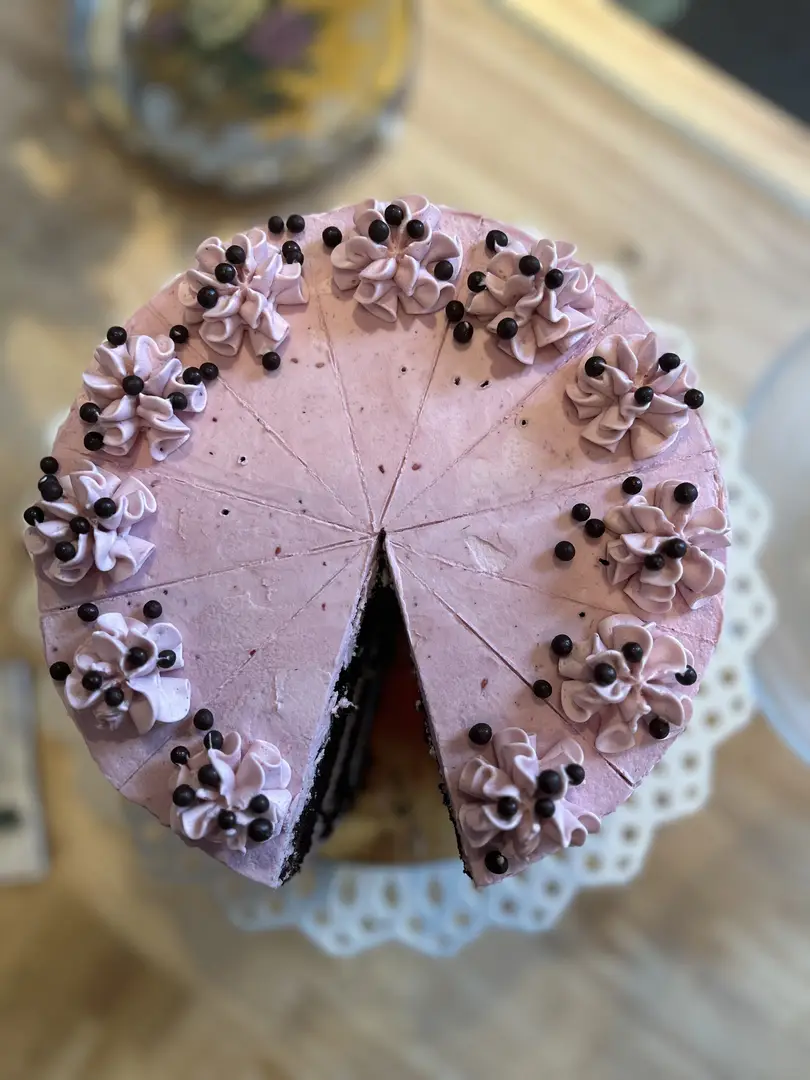 Purple frosted cake with chocolate dots.